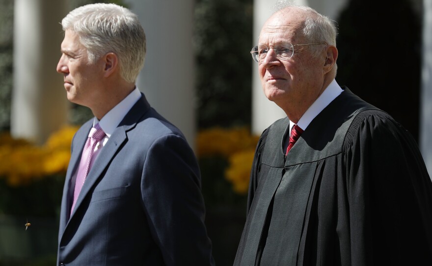 Kennedy (right) prepares to administer the judicial oath to Judge Neil Gorsuch during a ceremony in the Rose Garden at the White House in 2017.