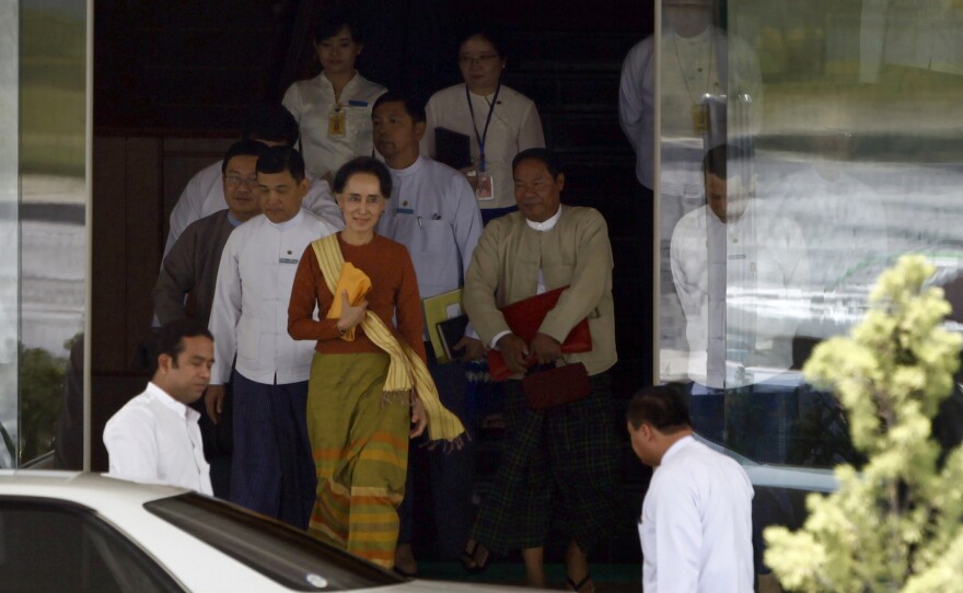Myanmar Foreign Minister Aung San Suu Kyi (center) walks out of her ministry in Naypyitaw on Friday. Her ally U Htin Kyaw took over as Myanmar's president Wednesday.