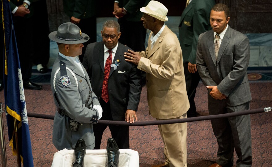Mourners view the body of state Sen. Clementa Pinckney as he lay in state at the South Carolina State House Wednesday. Pinckney will be buried Friday; two other victims of the June 17 shootings at Mother Emanuel Church will be buried Thursday.
