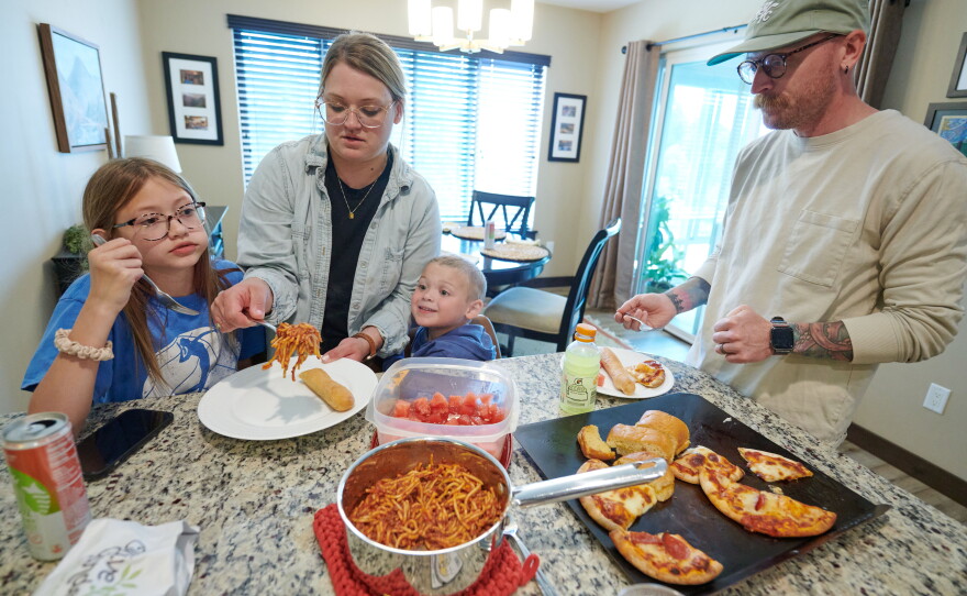 Amber and Neil Petersen serve lunch to two of their children, 11-year-old Eden and 4-year-old Jack, while visiting Amber's parents in Iowa City, Iowa.