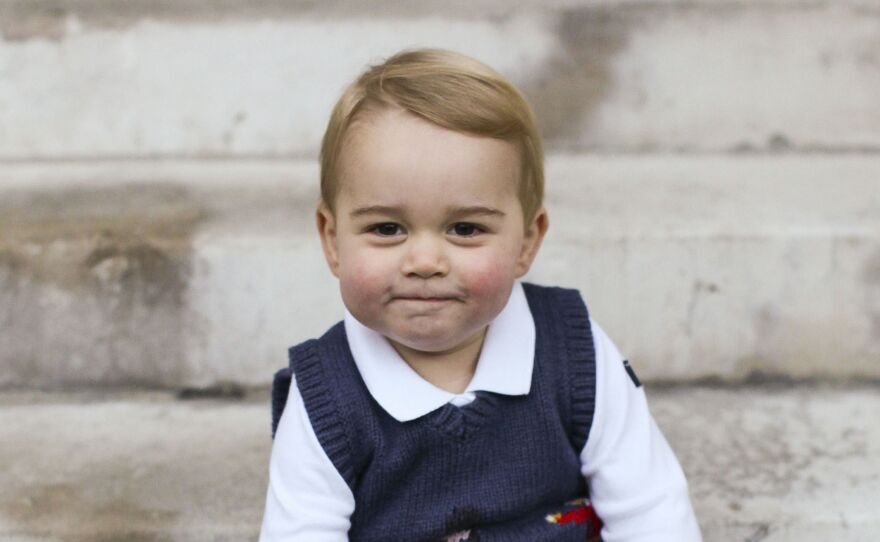 One of three Christmas images showing Prince George in a courtyard at Kensington Palace, central London.