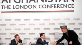 Afghan President Hamid Karzai (right) greets Britain's Foreign Minister David Miliband (center) and U.N. Secretary-General Ban Ki-moon Thursday during the opening session of the Afghanistan Conference in London on January 28, 2010.