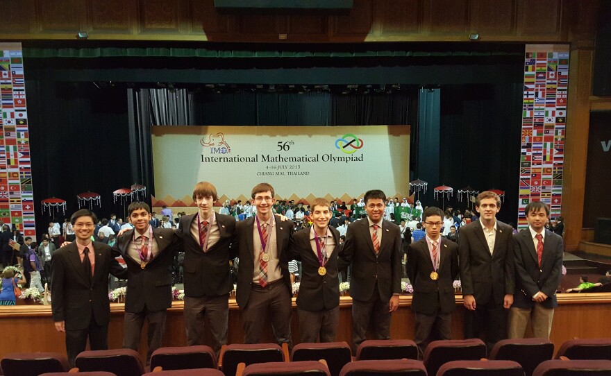 Head coach Po-Shen Loh (far left) and assistant coaches John Berman and Alex Zhai (far right) flank the members of the winning squad: Shyam Narayanan, David Stoner, Michael Kural, Ryan Alweiss, Yang Liu and Allen Liu.