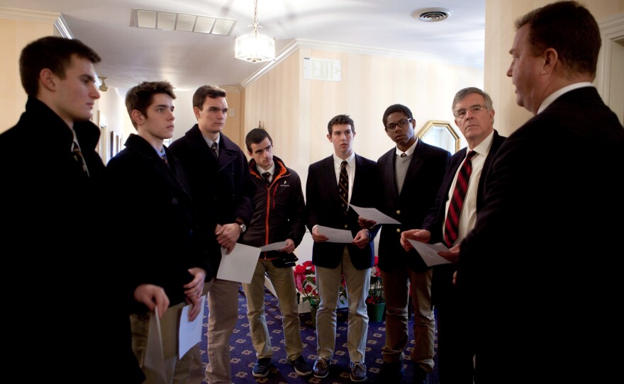 Roxbury Latin seniors Chris Rota, Liam McDonough, Emmett Dalton, Esteban Enrique, Brendan McInerney and Noah Piou, and assistant headmaster Mike Pojman, listen as funeral director Bob Lawler explains the circumstances of the death of Nicholas Mlller, whose body was unclaimed, at the Robert J. Lawler & Crosby Funeral Home.