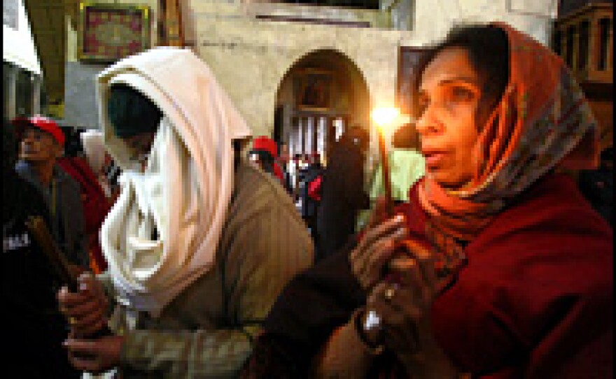 Christian pilgrims pray at the Church of Nativity in Bethlehem on Dec. 25, 2005.