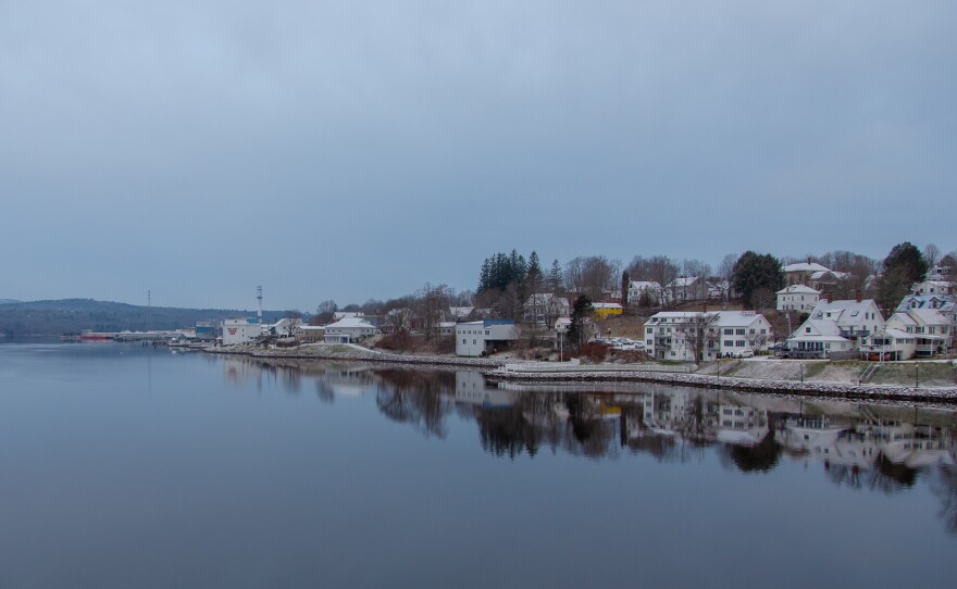 Bucksport, Maine waterfront along the Penobscot river, with the last remaining smoke stack from the town's former mill in the background.