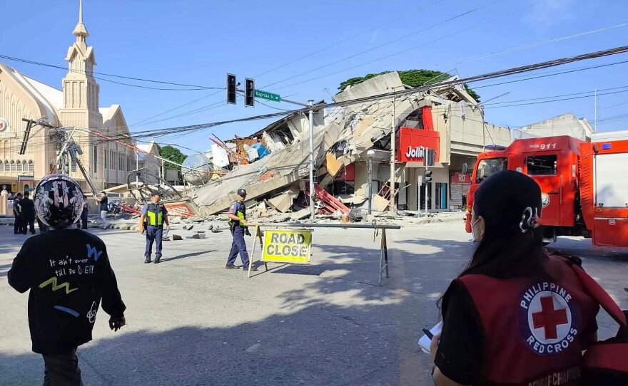 In this photo provided by the Philippine Red Cross, rescuers inspect the damage after an earthquake in General Santos, Philippines, Monday, June 8, 2026.