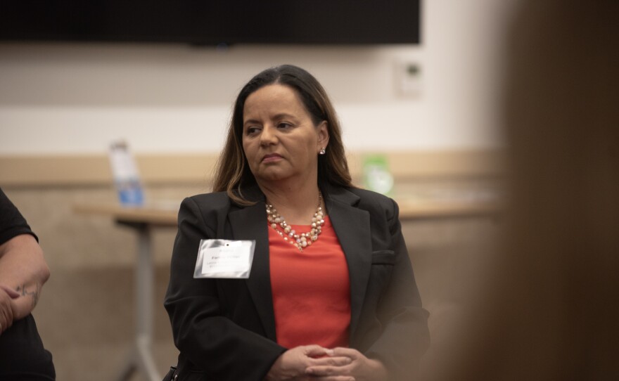 Fanny Miller discusses with other South Bay community leaders at the San Ysidro library on Tuesday, Feb. 20, 2024.