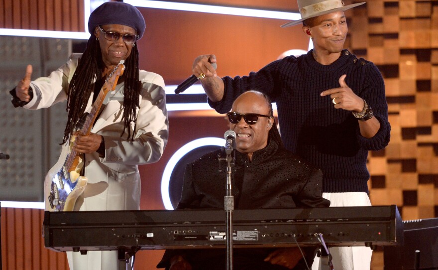 Nile Rodgers (left) and Pharrell Williams (right) on stage with Stevie Wonder during a performance of Daft Punk's "Get Lucky" during the 2014 Grammy Awards.