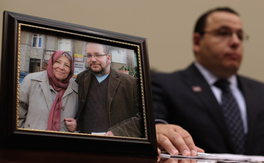 Ali Rezaian, brother of Washington Post Tehran Bureau Chief Jason Rezaian (shown in picture frame), talks about his brother's imprisonment in Iran while testifying before the House Foreign Affairs Committee on June 2, 2015. Iranian media outlets are reporting that Rezaian has been released.