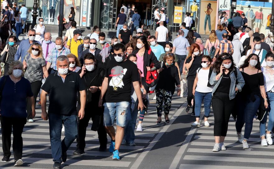 Face masks definitely help keep the coronavirus at bay — and are embraced by most people in this scene from Ankara. But what about earlier recommendations to keep 6 feet from others and limit close contact to 15 minutes. With the highly contagious delta variant, are these still effective protective measures?