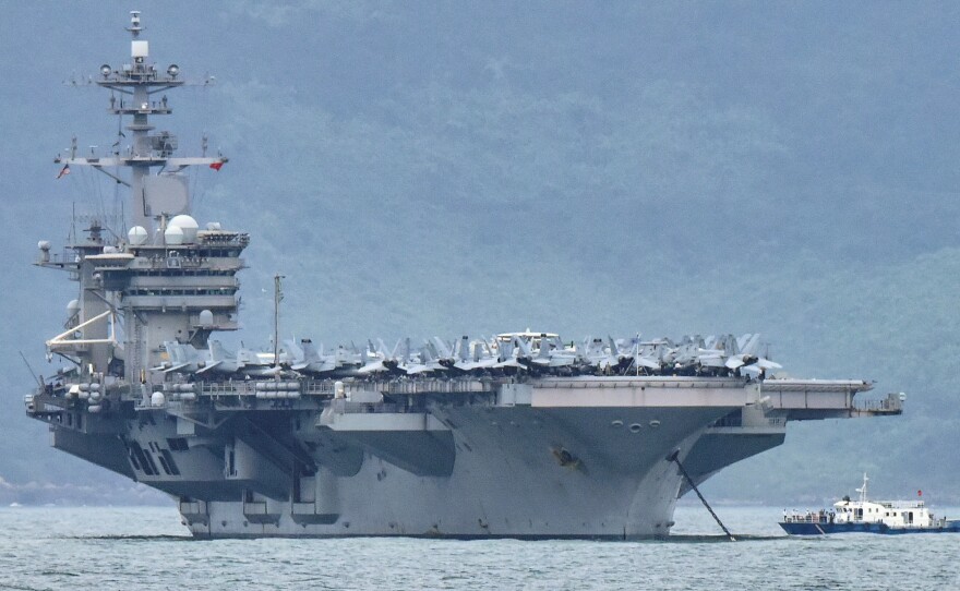 The acting secretary of the Navy is seeking a more thorough review of "decisions of the chain of command surrounding the COVID-19 outbreak aboard the USS Theodore Roosevelt." The aircraft carrier is seen here as it enters the port in Da Nang, Vietnam, last month.