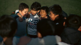 Children in Asian Refugees United's Soccer for Success program huddle during soccer practice in Harrisburg, Pa., on April 16, 2025.