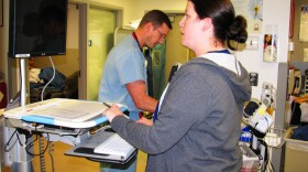 Emergency room Dr. Scott Freiwald examines a patient as nurse Becky Welburn enters all of the relevant information into a computer so all hospital staff can have easy access to it. 