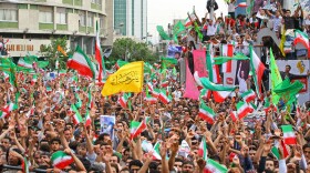 Supporters of President Mahmoud Ahmadinejad celebrate during a rally at Valiasr square on June 14, 2009 in Tehran, Iran. Crowds of people gathered in central Tehran to celebrate the re-election of Iran's President Mahmoud Ahmadinejad, who won a second four-year term in a landslide election victory on June 12. 