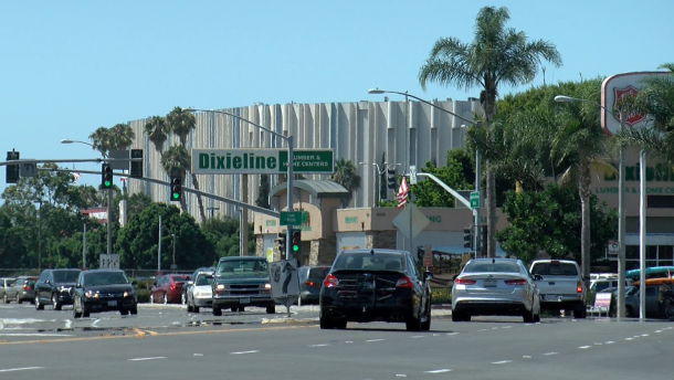Cars drive along a street in the Midway District with the Valley View Casino Center in the background, Aug. 29, 2018.