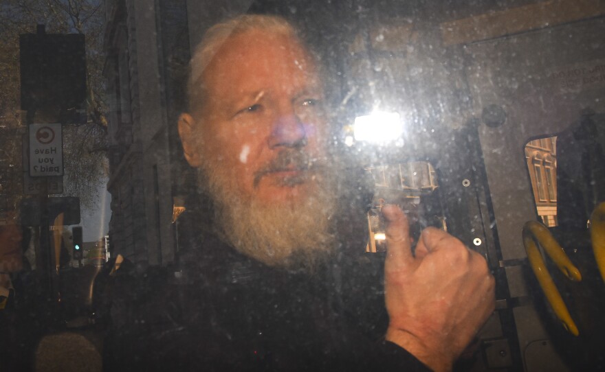 WikiLeaks founder Julian Assange makes his way into the Westminster Magistrates' Court after being arrested April 11 in London.