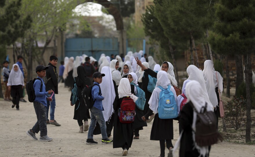 Afghan students leave classes in a primary school in Kabul, on March 27, 2021.