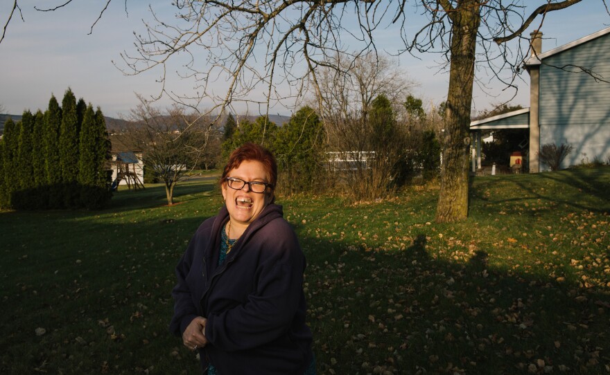 Pauline stands in her neighborhood. She is slowly adjusting to her new life away from Brooklyn.