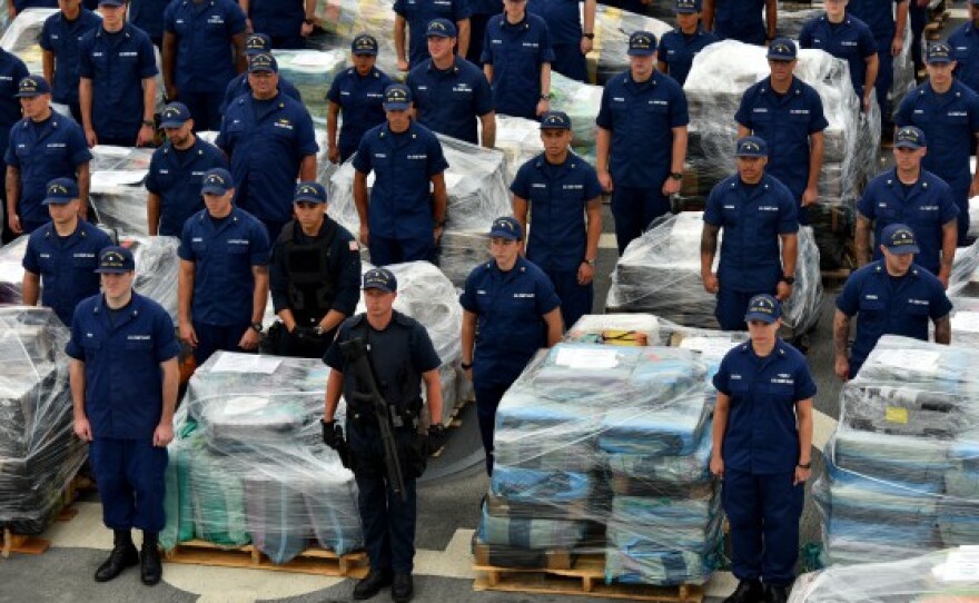 The crew of the Coast Guard cutter Stratton stands by to offload 34 metric tons of cocaine in San Diego on Monday, Aug. 10, 2015.