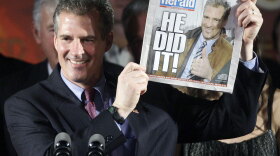 Massachusetts state Sen. Scott Brown (R-Wrentham) holds a copy of the <em>Boston Herald</em> as he celebrates after winning Tuesday's special election, held to fill the U.S. Senate seat left vacant by the death of Sen. Edward Kennedy.