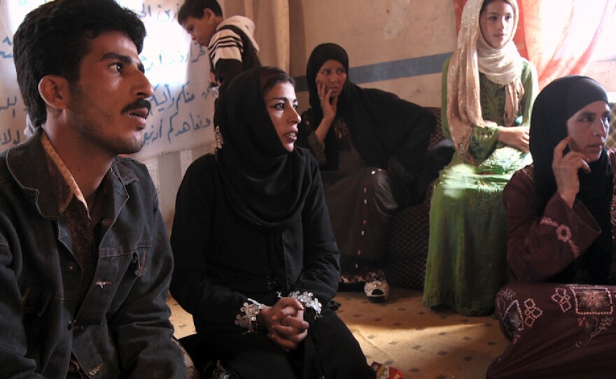 Rafea, Badr and Umm Badr at a village meeting after returning from India.