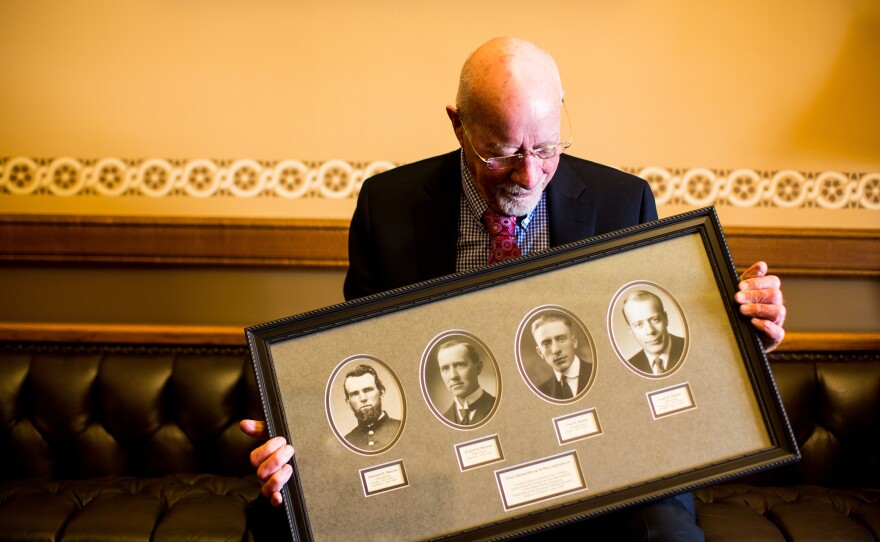 Risser holds a frame with photos of four generations of legislators in his family. His father, Fred E. Risser was a state senator; his grandfather, Ernest Warner, was an assembly member; and his great-grandfather, Clement Warner, was a state senator and assembly member following the Civil War.