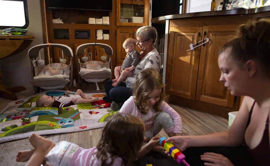 Chelsea watches Harper and Riley while Kim plays with August and Bishop, in their RV. Noah and Chelsea don't know how it will feel to be back in their house, one of the first on their street to be rebuilt.