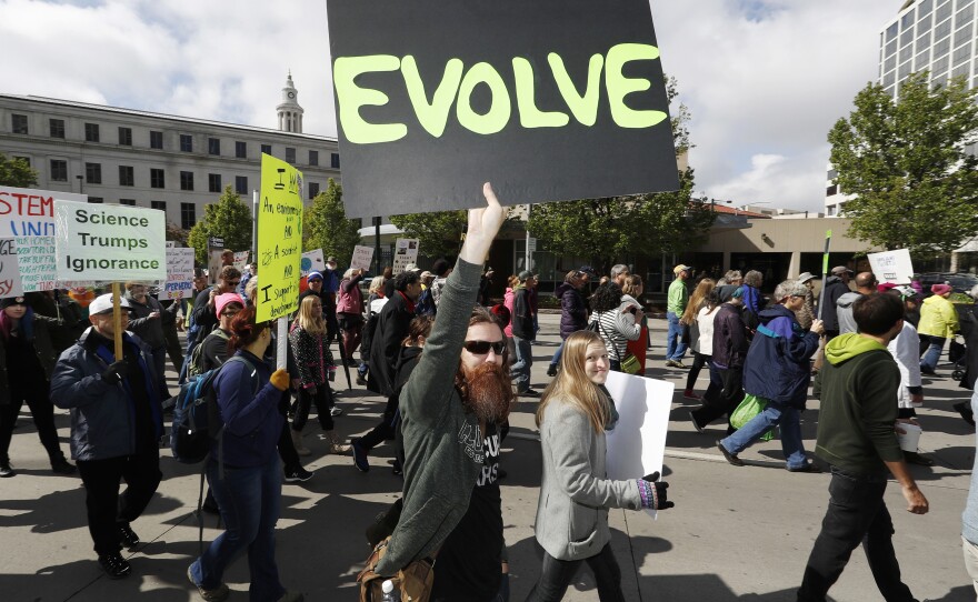 Protesters wave signs during the March for Science in Denver, Colo. The organizers don't expect the event to end on Saturday. They've planned a week of action for April 23 through 29.