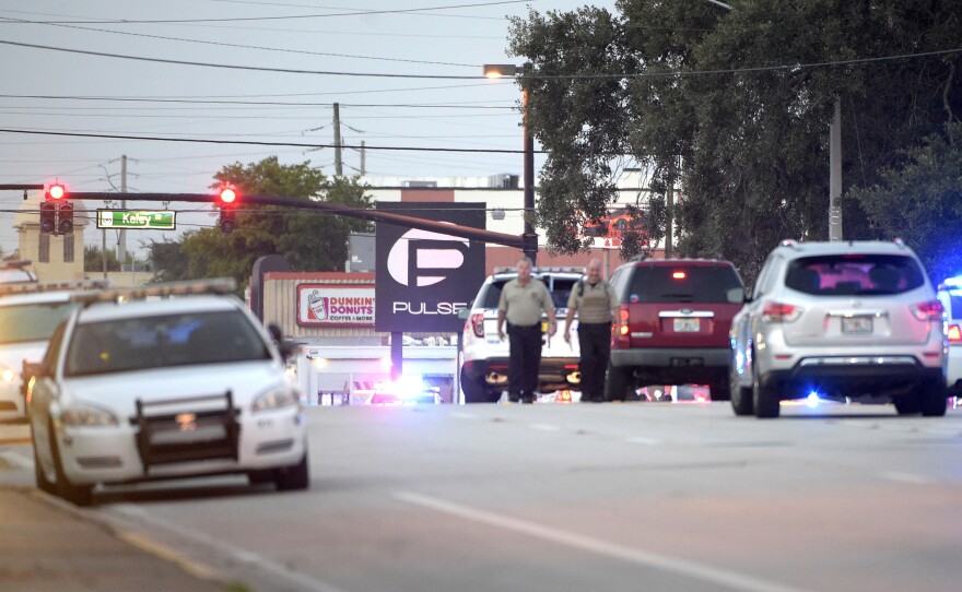 Police cars surround the Pulse Orlando nightclub, the scene of a fatal shooting, in Orlando, Fla.