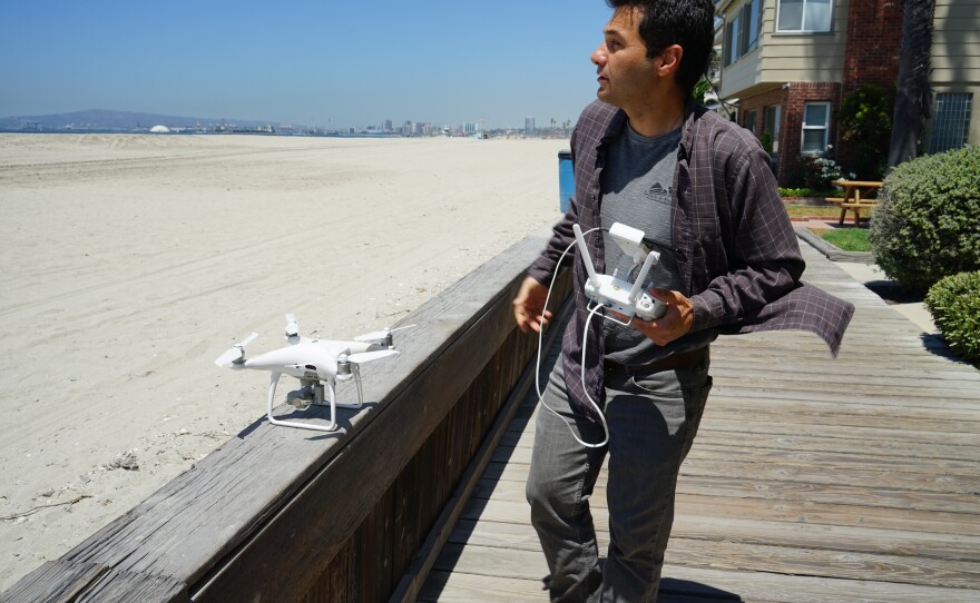 Juliano Calil prepares to launch his drone over Long Beach, Calif., for a virtual reality program he's creating to simulate the effects of sea level rise on the area.