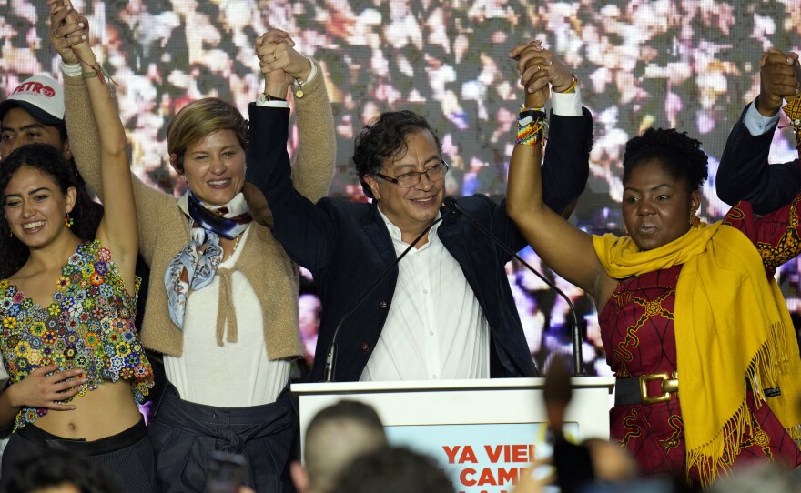 Presidential candidate Gustavo Petro, center, and his running mate Francia Marquez, at his right stand before supporters on election night in Bogota, Colombia, Sunday.