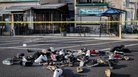 Shoes of victims are piled at the scene of Sunday's mass shooting in Dayton, Ohio.