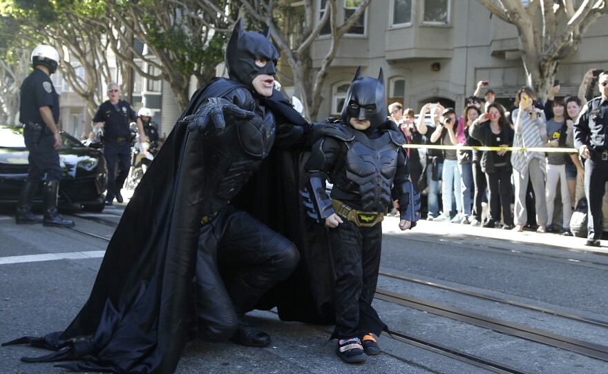 Miles Scott, dressed as Batkid, talks strategy with Batman before saving a woman from peril in San Francisco on Friday. The Make-A-Wish Foundation turned San Francisco into Gotham City for Miles, creating a daylong event to grant the leukemia survivor's wish to be a superhero.