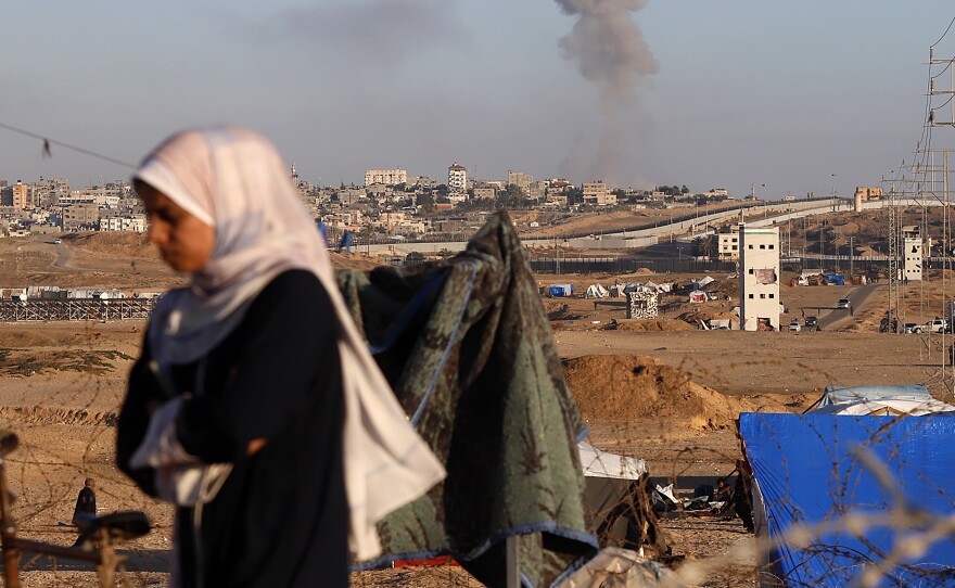 Smoke rises following an Israeli airstrike on buildings near the separating wall between Egypt and Rafah, southern Gaza Strip, on Monday.