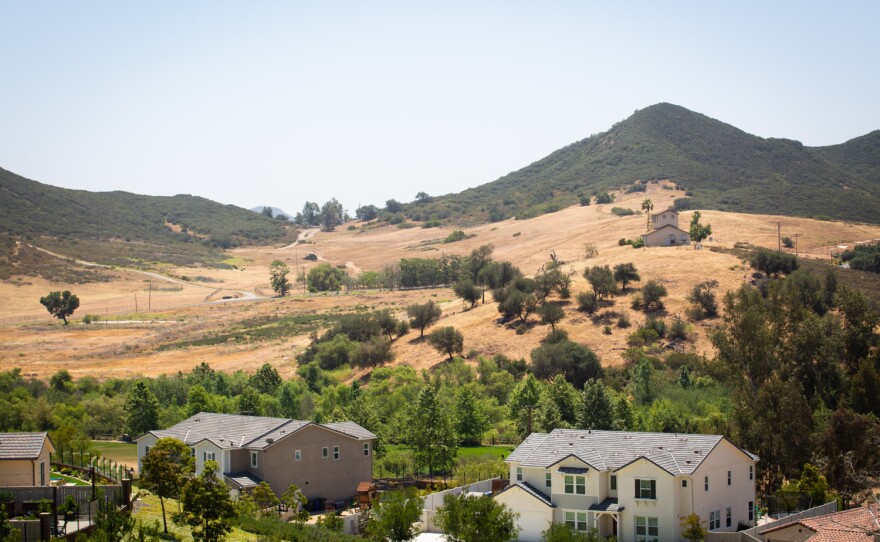 Homes from the Harmony Grove Village community in Escondido are shown in front of an area proposed for a new housing development, May 17, 2022