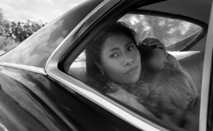 Yalitza Aparicio as Cleo, Marco Graf as Pepe, and Daniela Demesa as Sofi in <em>Roma</em>, written and directed by Alfonso Cuarón.