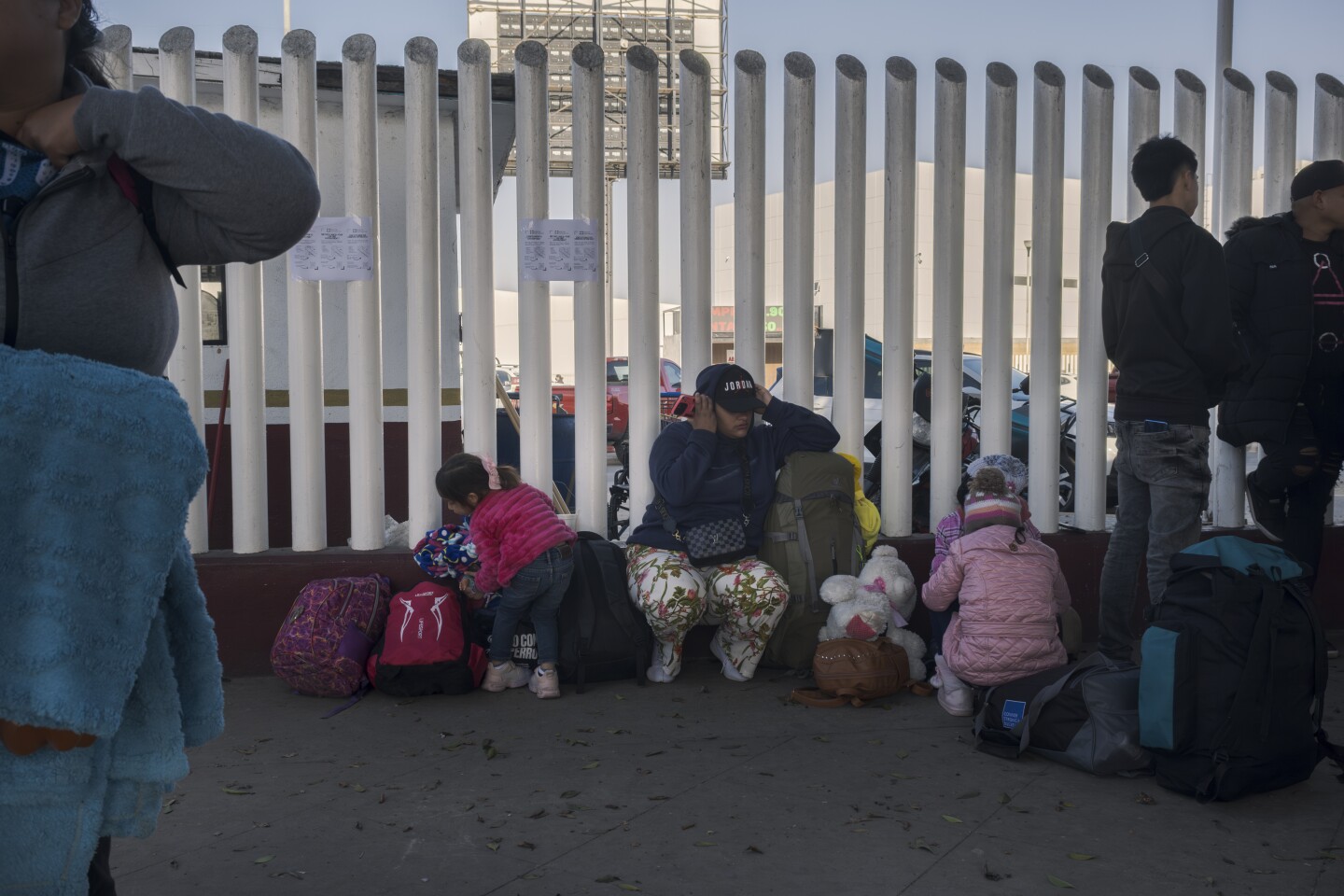 Migrants line up at the El Chaparral border crossing into the United States hoping to get answers about their asylum appointment cancellations after the American government cancels all appointments made through the CBP One app. Jan. 21, 2025 in Tijuana, Mexico.