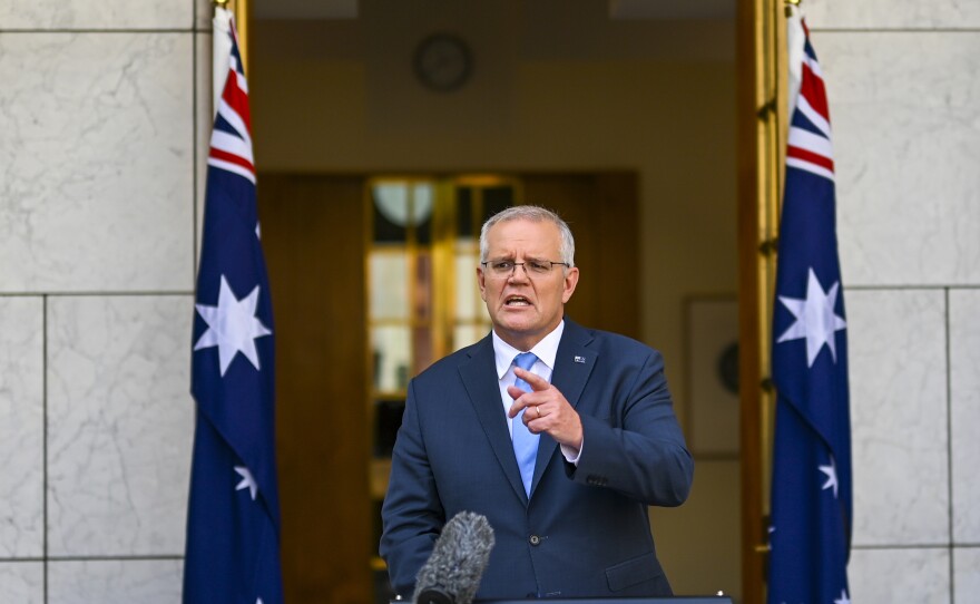 Australian Prime Minister Scott Morrison gestures during a news conference at Parliament House in Canberra, Australia, Sunday, April 10, 2022.