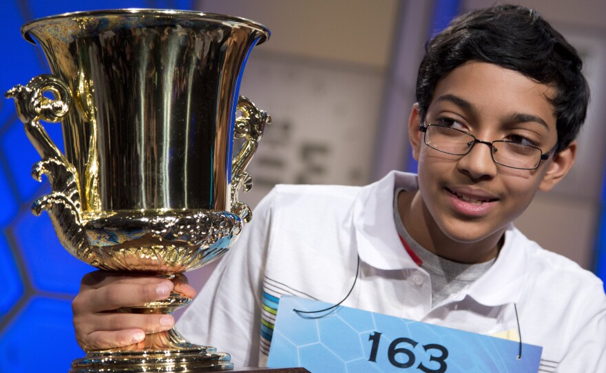 Arvind Mahankali, 13, of Bayside Hills, N.Y., holds the championship trophy after he won the National Spelling Bee by spelling the word "knaidel" correctly on Thursday in Oxon Hill, Md.