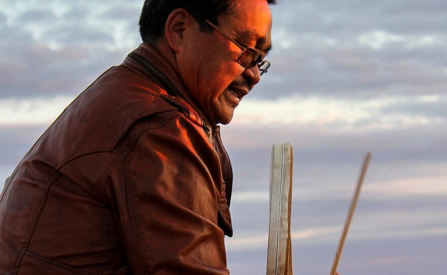 Anda Poulsen plays the traditional Inuit drum and sings the old songs by the ocean in Nuuk.