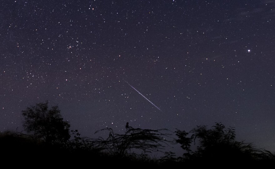 This photo taken late Dec. 14, 2018 with a long time exposure shows a meteor streaking through the night sky over Myanmar during the Geminid meteor shower seen from Wundwin township near Mandalay city.