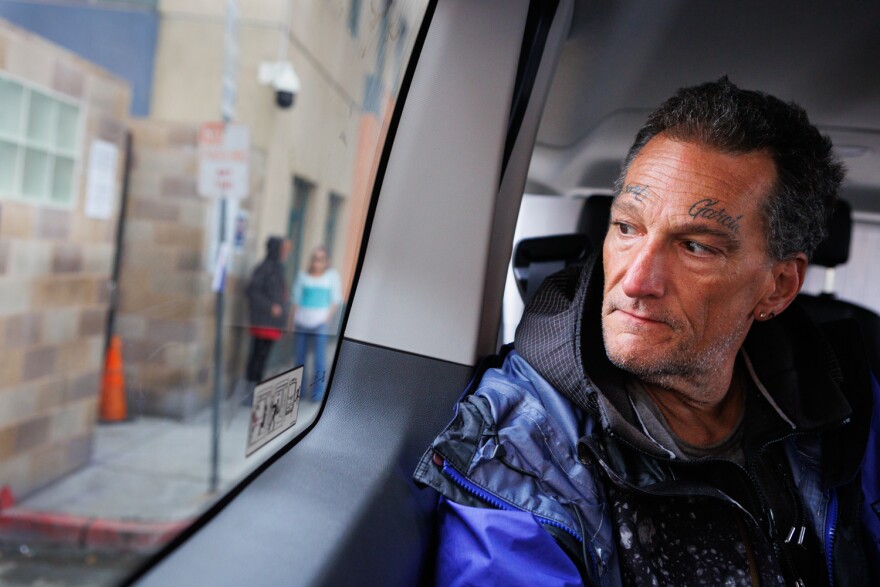 Kenneth Garcia arrives at a shelter with Alpha Project outreach workers in San Diego, April 18, 2023. After sleeping outside for a week a bed opened for him.