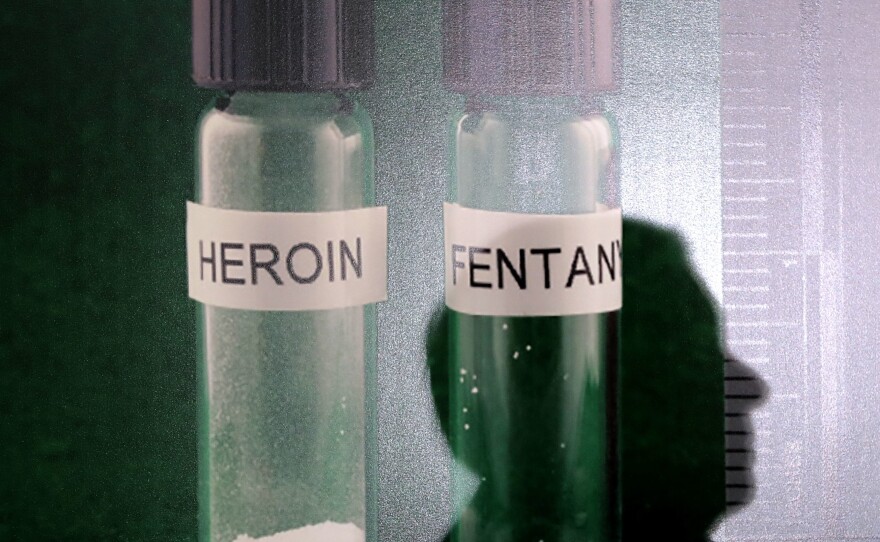 The shadow of Sen. Lindsey Graham is cast on a photograph of heroin and Fentanyl during a news conference at the U.S. Capitol in 2018. Officials across the country have tried to stem the opioid crisis over the past decade.