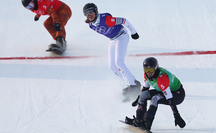 Jacobellis reacts after crossing the finish line to win the gold medal during the women's snowboard cross big final at the Beijing 2022 Winter Olympic Games.