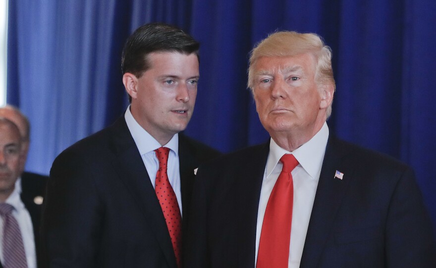 Ousted White House staff secretary Rob Porter speaks to President Trump after remarks he made on violence in Charlottesville, Va., in August 2017 at Trump National Golf Club in Bedminister, N.J.