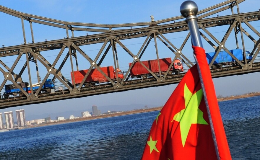 Trucks loaded with Chinese goods head across the Yalu Bridge and into North Korea one day after the memorial service for the late leader Kim Jong Il, at the Chinese North Korean border town of Dandong on December 30, 2011.