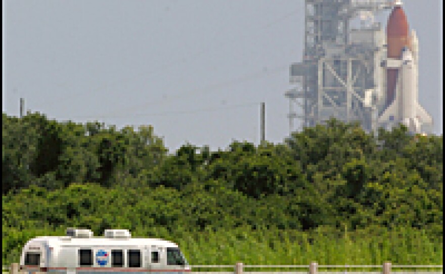 Space shuttle Discovery astronauts ride in the astrovan on their way to boarding the shuttle at Kennedy Space Center July 2, 2006, in Cape Canaveral, Fla. The launch was later halted due to poor weather.
