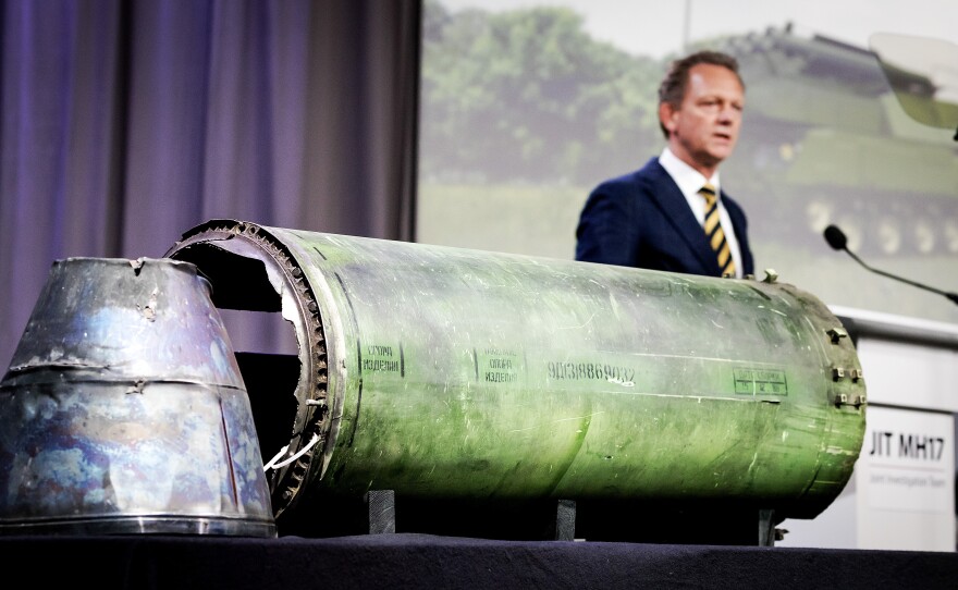 Head prosecutor Fred Westerbeke speaks next to a part of the Buk rocket that was fired on Flight MH17 during the news conference of the Joint Investigation Team in Bunnik, Netherlands, on Thursday.