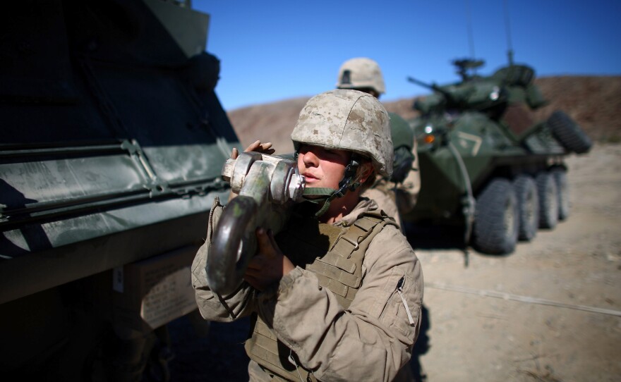 Lance Cpl. Julia Carroll holds a tow-bar after pulling a LAV.